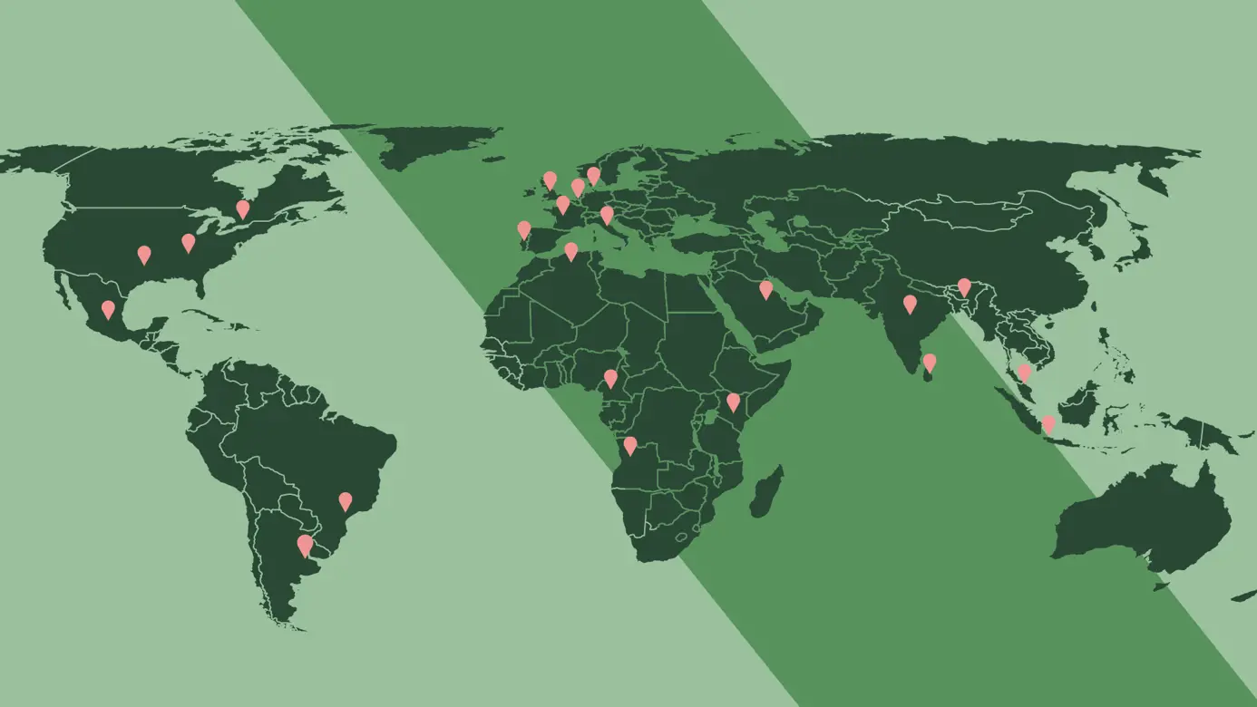 green illustration of a world map with light red pins